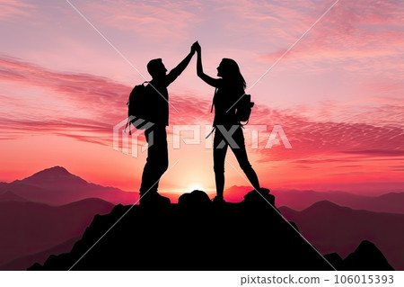 Silhouette of a couple on top of a mountain at sunset 106015393