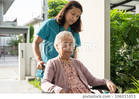 Caregiver help and care Asian senior woman patient sitting on wheelchair to ramp in hospital, healthy strong medical concept. 106015853