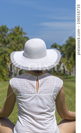 Young woman doing yoga exercises in park Young woman doing yoga exercises in park 106016716
