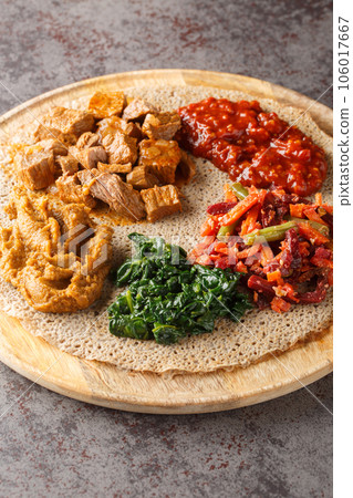 Injera firfir flatbread typical Ethiopian breakfast food close up. Vertical Injera firfir flatbread typical Ethiopian breakfast food close up. Vertical 106017667