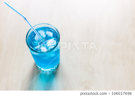 blue cocktail in glass with drinking straw blue cocktail in glass with drinking straw 106017696