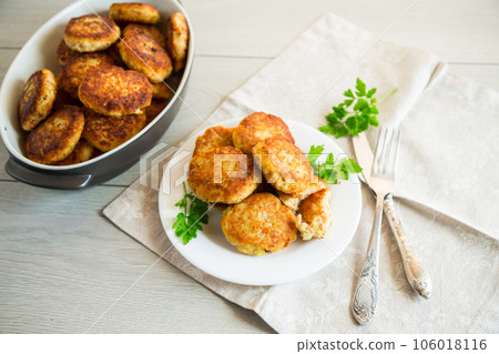 Cooked fried fish cutlets in a plate with herbs. 106018116