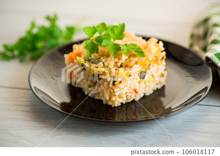 Cooked boiled rice with zucchini, carrots and vegetables in a plate 106018117