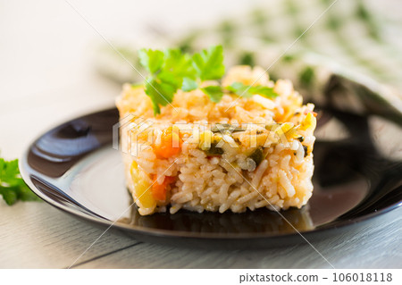 Cooked boiled rice with zucchini, carrots and vegetables in a plate 106018118