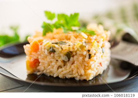 Cooked boiled rice with zucchini, carrots and vegetables in a plate 106018119