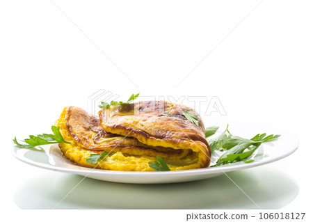 Fried omelette with zucchini,in a plate on a white background. Fried omelette with zucchini,in a plate on a white background. 106018127