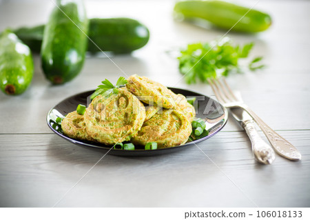 Fried squash green pancakes in a plate. 106018133