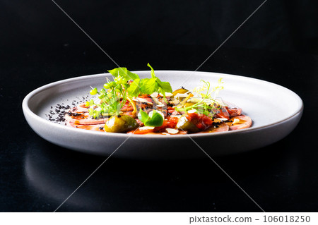 Beef tongue with sauce and vegetables on a white plate Beef tongue with sauce and vegetables on a white plate 106018250