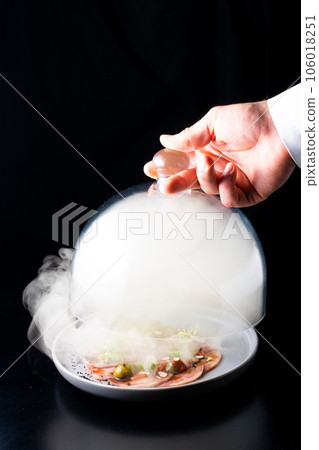 Beef tongue with sauce and vegetables on a white plate 106018251