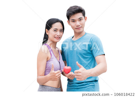 Young couple holding articulation red mock up heart with poses thumbs up Young couple holding articulation red mock up heart with poses thumbs up 106018422
