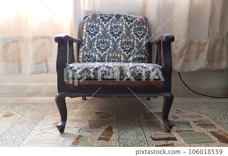 closeup view of a sofa or an old wooden armchair isolated on terrazzo surface 106018559