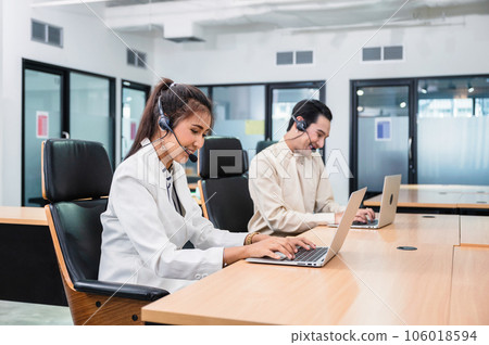 Young asian operator woman agent with headsets working customer service in a call center Young asian operator woman agent with headsets working customer service in a call center 106018594