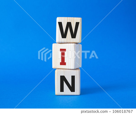 Win symbol. Wooden blocks with words Win. Beautiful blue background. Business and Win concept. Copy space. 106018767
