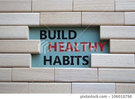 Healthy habits symbol. Concept word Build Healthy habits on wooden blocks. Beautiful grey green background. Healthy lifestyle and Healthy habits concept. Copy space Healthy habits symbol. Concept word Build Healthy habits on wooden blocks. Beautiful grey green background. Healthy lifestyle and Healthy habits concept. Copy space 106018798