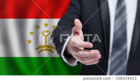 Tajik business, politics, cooperation and travel concept. Hand on flag of Tajikistan background. 106019423