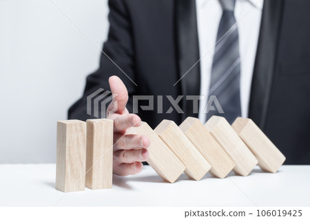Wooden blocks under protection, domino, insurance safety concept 106019425