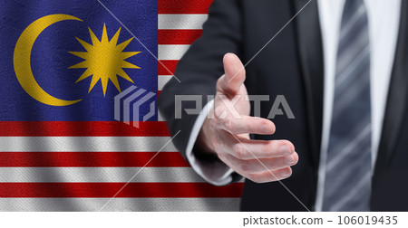 Malaysian business, politics, cooperation and travel concept. Hand on flag of Malaysia background. Malaysian business, politics, cooperation and travel concept. Hand on flag of Malaysia background. 106019435