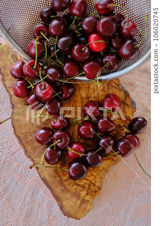 ripe cherries scattered on a wooden board ripe cherries scattered on a wooden board 106020745