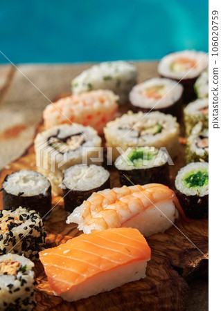 assorted sushi on a board near the pool 106020759