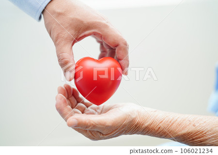 Asian woman doctor holding red heart for health in hospital. 106021234