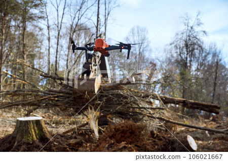 Environmental services are utilizing drones to monitor the uprooting of trees in construction site. 106021667