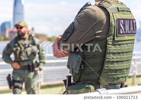 equipped swat soldier standing on a peir equipped swat soldier standing on a peir 106021713