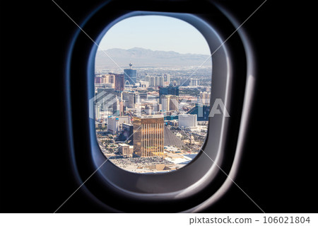 Las Vegas view through a jet plane window high on the blue sky 106021804