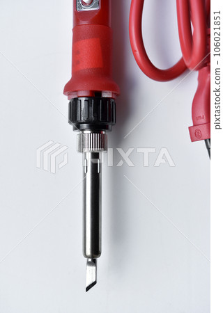 Red soldering iron on a white background. A tool for repairing electronics. Red soldering iron on a white background. A tool for repairing electronics. 106021851