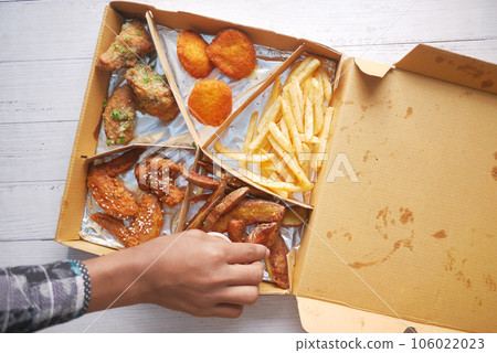 French Fries or Chips and chicken wings in a takeaway packet French Fries or Chips and chicken wings in a takeaway packet 106022023