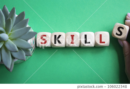 Skills symbol. Concept word Skills on wooden cubes. Businessman hand. Beautiful green background with succulent plant. Business and Skills concept. Copy space. 106022348