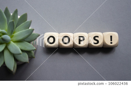 Oops symbol. Concept word Oops on wooden cubes. Beautiful grey background with succulent plant. Business and Oops concept. Copy space. Oops symbol. Concept word Oops on wooden cubes. Beautiful grey background with succulent plant. Business and Oops concept. Copy space. 106022436