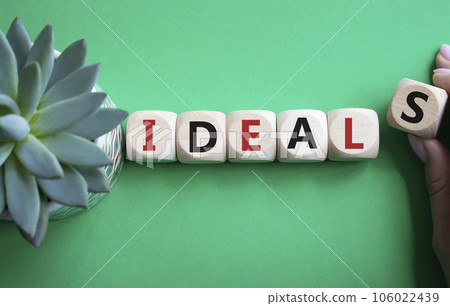 Ideals symbol. Wooden blocks with word Ideals. Businessman hand. Beautiful green background with succulent plant. Business and Ideals concept. Copy space. Ideals symbol. Wooden blocks with word Ideals. Businessman hand. Beautiful green background with succulent plant. Business and Ideals concept. Copy space. 106022439