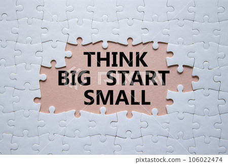 Think big start small symbol. Concept words Think big start small on white puzzle. Beautiful pink background. Business and Think big start small concept. Copy space Think big start small symbol. Concept words Think big start small on white puzzle. Beautiful pink background. Business and Think big start small concept. Copy space 106022474