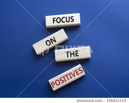 Focus on the Positives symbol. Concept words Focus on the Positives on wooden blocks. Beautiful deep blue background. Business concept. Copy space. 106022518