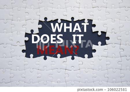 What does it mean symbol. White puzzle with words What does it mean. Beautiful black background. Business and What does it mean concept. Copy space. 106022581