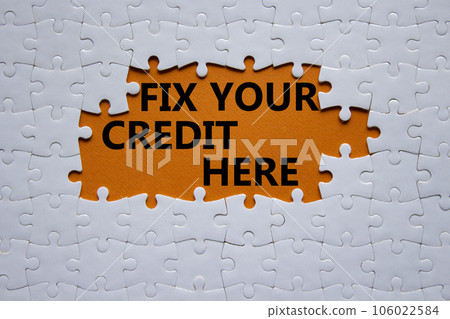 Fix your credit here symbol. Concept words Fix your credit here on white puzzle. Beautiful orange background. Business and Fix your credit here concept. Copy space. 106022584