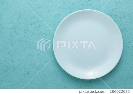 Empty Blue Ceramic Plate on Blue Cement background. Top view, copy space 106022623