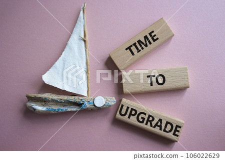 Time to Upgrade symbol. Concept words Time to Upgrade on wooden blocks. Beautiful pink background with boat. Business and Time to Upgrade concept. Copy space. Time to Upgrade symbol. Concept words Time to Upgrade on wooden blocks. Beautiful pink background with boat. Business and Time to Upgrade concept. Copy space. 106022629