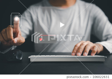 Step into the virtual dimension as a man's hand touches the screen, indulging in online videos, live concerts, and the cutting-edge concept of digital technology. 106022631