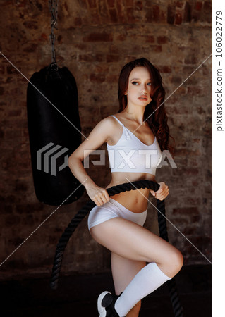 Woman holding sports rope in the gym 106022779