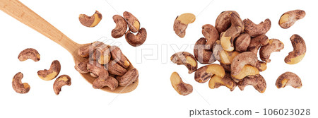 cashew nuts heap with shell in wooden spoon isolated on white background. Top view. Flat lay 106023028