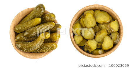 Marinated pickled cucumber in wooden bowl isolated on white background with full depth of field. Top view. Flat lay 106023069