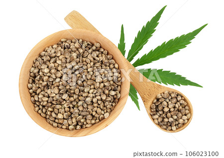 Hemp seeds in wooden bowl isolated on white background with full depth of field. Top view. Flat lay 106023100