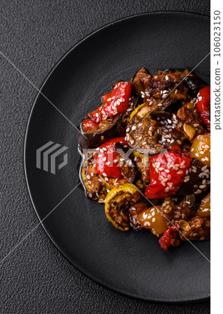 Delicious juicy fresh salad of baked eggplant, tomatoes, sweet peppers, sesame seeds Delicious juicy fresh salad of baked eggplant, tomatoes, sweet peppers, sesame seeds 106023150