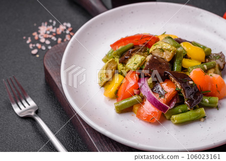 Delicious juicy fresh salad of baked eggplant, tomatoes, zucchini, onions, spices and salt Delicious juicy fresh salad of baked eggplant, tomatoes, zucchini, onions, spices and salt 106023161
