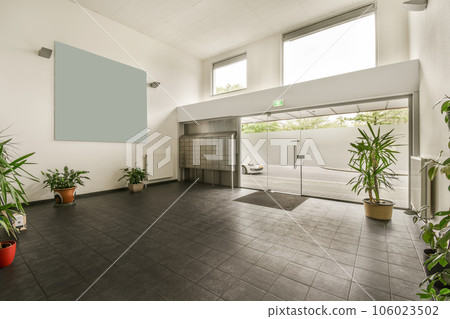 the inside of a house with plants in pots on the floor and an open door that leads to another room the inside of a house with plants in pots on the floor and an open door that leads to another room 106023502