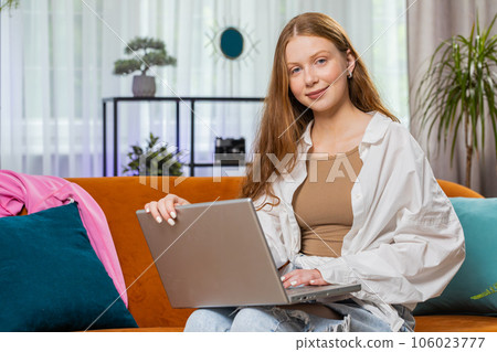 Teenager girl freelancer starts working on laptop, sends messages, makes online purchases at home Teenager girl freelancer starts working on laptop, sends messages, makes online purchases at home 106023777