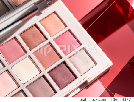 A close-up of pearlescent shimmery palette of pink eyeshadows for creating eye makeup 106024327