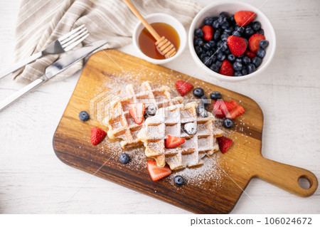 belgium waffle with strawberry, blueberry and honey 106024672