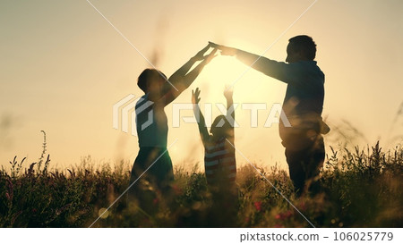 silhouette roof house. buy family home. house symbol. apartment dream sign. roof house. mother father child happy family sunset. holding hands family silhouette. epoteka loan purchase residential 106025779